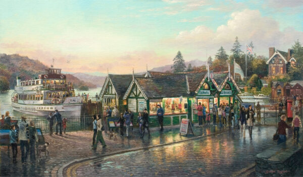 A print of Graham Twyford's Bowness at Dusk. The boat tour ticket box is light by a golden light which is reflected on the damp ground along Bowness
