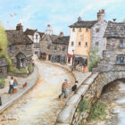 Lake District art framed print of Bridge House, Ambleside by Janice McGloine with shops and people walking on the streets in her quirky illustrative style.