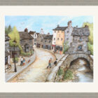 Lake District art framed print of Bridge House, Ambleside by local artist Janice McGloine in a grey frame.