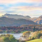 Lake District art photographic print Langdale Pikes and Windermere by Jon Allison is a panoramic view with the lake and fields in the foreground.