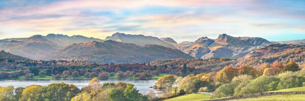 Lake District art photographic print Langdale Pikes and Windermere by Jon Allison is a panoramic view with the lake and fields in the foreground.