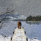 Lake District art print We Love Snow and Windermere by local artist Jeff Sudders. A couple stand on a jetty looking out to Belle Isle and Hawkshead with hills beyond whilst heart shaped snowflakes fall.