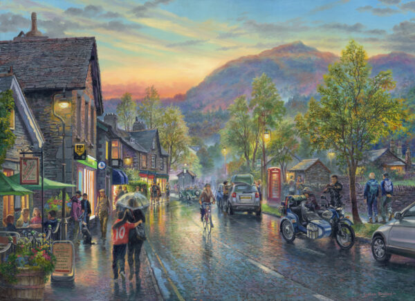 Open edition print by Graham Twyford. A populat destination in the Lake District Grasmere. Late afternoon, bright yellow light are on in the houses, the road looks wet like it has just rained, a few people strolling through the village.