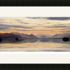 Lake District art framed print Evening Reflections on Derwentwater by local artist Jeff Sudders in a black frame.