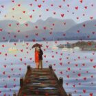 Lake District art print Love in the Lakes Low Wood by local artist Jeff Sudders. A couple stand on the jetty and red hearts fall from the sky.