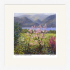 Lake District Art framed print Magnolia Tree and Derwentwater by Jeff Sudders. A pink magnolia tree is in bloom on the edge of Derwentwater with mountain range behind.