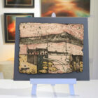 Landscape Tile by Cumbrian sculptural artist Nigel Edmondson. Hand-built using techniques in slab construction, coiling, throwing and often both in combination. Each piece is fired to a temperature of 1250C in oxidation, ensuring his creations can endure all weathers for the years to come. Using various small slabs of clay, each with a different colouring or level of oxidization, this textured tile shows a snippet of te Lake District landscape. Showing small farmhouse amongst the fields with the fells standing tall in the distance. A simple yet beautiful use of the clay medium.
