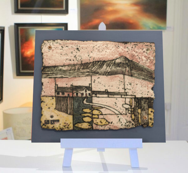 Landscape Tile by Cumbrian sculptural artist Nigel Edmondson. Hand-built using techniques in slab construction, coiling, throwing and often both in combination. Each piece is fired to a temperature of 1250C in oxidation, ensuring his creations can endure all weathers for the years to come. Using various small slabs of clay, each with a different colouring or level of oxidization, this textured tile shows a snippet of te Lake District landscape. Showing small farmhouse amongst the fields with the fells standing tall in the distance. A simple yet beautiful use of the clay medium.