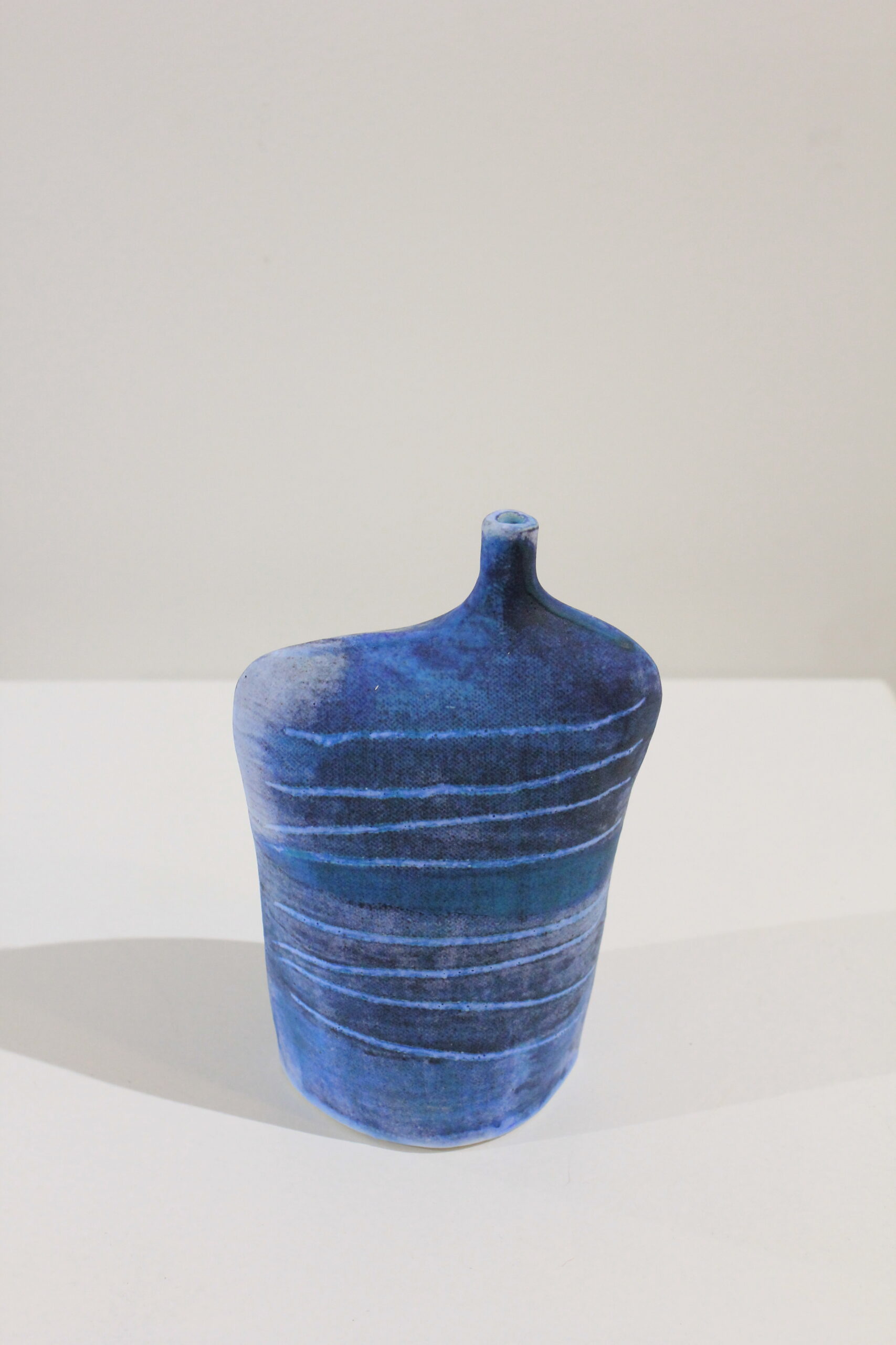 Tracks Medium Wide Bottle 1 by Kirsti Hannah Brown Stoneware bottle handbuilt by Kirsti Hannah Brown. Slip and sgraffito create the colour and atmosphere of dark sea and skies.