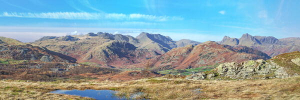 bright autumnal day looking over to the langdale pikes from black crag near tarn hows in the lake district panoramic photograph by jon allison