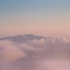 Blencathra Framed Print by Lake District Photographer Nathan Buckley. An atmospheric shot of the well know mountain near Keswick. Blencathra is emerging above the clouds in hues of pink