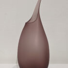Handmade large pod vase in burgundy shade from a side view showing rounded form.