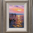 Lake district art by Andrew Grant-Kurtis. Sunshine Breeze Derwentwater features a reflective pink and purple sunset over the lake with distant mountains boats and trees.