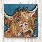 Ceramic wall tile with metal hook of a Highland Cow by Dawn Maciocia