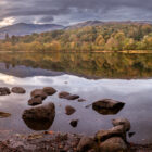 Lake District Art Photographer Print by local artist Nathan Buckley. Autumn reflections over coniston water featuring old man of coniston yew pike and wetherlam