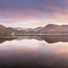 Lake District Art Photographer Print by local artist Nathan Buckley. evening colour over ullswater lake with sunset over hallin fell high street high dodd place fell