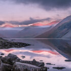 Lake District Art Photographer Print by local artist Nathan Buckley. wolf moon over wastwater pink light over yewbarrow great gable wasdale head lingmell scafell pike and the screes