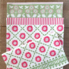 Organic cotton tea towel in Miller Honeyman's pink sunburst design.