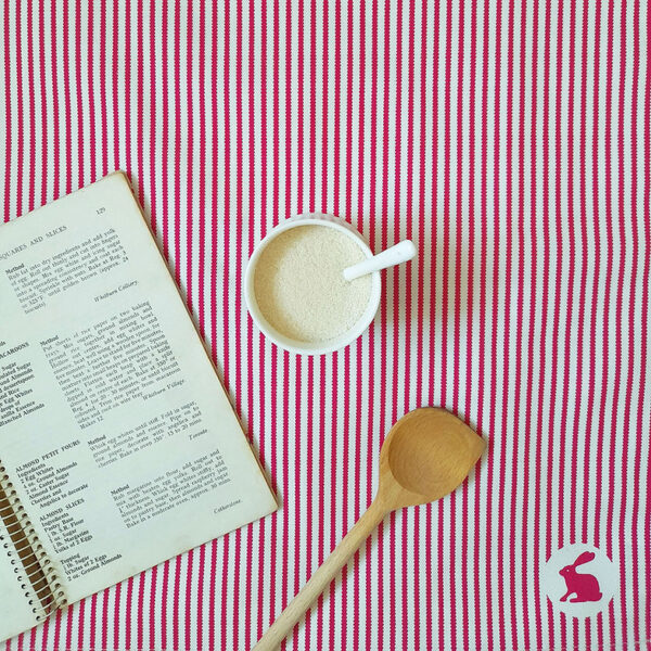 Organic cotton tea towel in pink Ribbon Stripe design by Miller Honeyman.