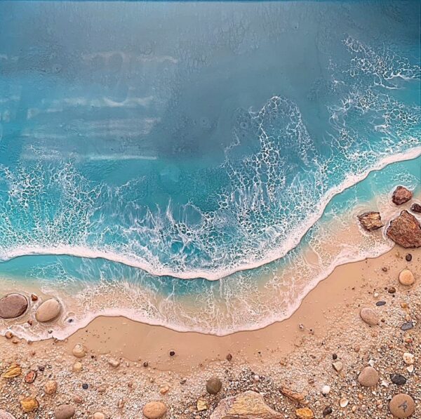 Lake District art gallery. Breaking Waves by Tamsin Pease. A resin mixed media piece with mica powders and acrylic inks. Real sand and pebbles used to create an aerial shoreline