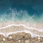 Lake District art gallery. Shoreline Haven by Tamsin Pease. A resin mixed media piece with mica powders and acrylic inks. Real sand and pebbles used to create an aerial shoreline