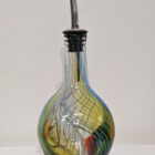 Handblown glass oil pourer in king fisher feather colours. Yellow, blue, red and greens. Rounded bottle bottom.
