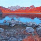 Art print by Lake District artist Libby Edmondson of Blea Tarn II. Vibrant orange and blue view over rocks in langdale