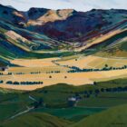 Art print by Lake District artist Libby Edmondson of Every Valley features a spring / summer view of vast green and yellow fields with distant mountains