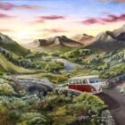 Lake District art original acrylic painting by Caroline Deighton. The adventure ahead featuring red Volkswagen camper van on bendy roads. Lake and hills in the background while the sunsets.