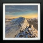 Lake District art original oil painting by Ben Goymour. The sun rises over a winter snow scene on striding edge near helvellyn from lad crag
