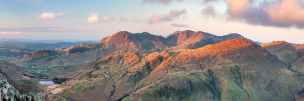 A beautiful photographic print by Jon Allison. The Wetherlam fells lit up at dawn with Blea Tarn below.