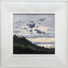 lake district art original oil painting by local artist Jeff Sudders. A moody sky with dark clouds and lake Windermere showing in the distance sailboats floating on the water. Woodland in the foreground. Displayed in a white wood grain frame.