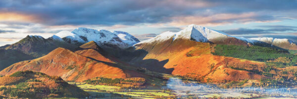 snowy mountains and a strong sunlight illuminaTE THIS WINTERY LANDSCAPE PHOTOGRAPH OF THE LAKE DISTRICT INCLUDING CATBELLS NEAR DERWENTWATER BY PHOTOGRAPHER JON ALLISON