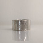 A chunky silver ring with a printed raindrop pattern along the band. Approximately 0.73” in diameter.