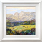 Lake District art original oil painting by local artist Jeff Sudders. A vibrant piece yellow fields and colourful woodland looking towards the Langdale Pikes. Displayed in a white cushioned frame.