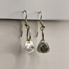 Handcrafted silver earrings featuring a printed raindrop pendant. Approximately 1.75” in length. Side view