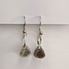 Handcrafted silver earrings featuring a printed raindrop pendant. Approximately 1.75” in length.