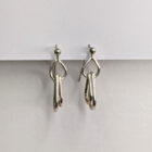 Handcrafted silver earrings featuring a trio of raindrop pendants. Approximately 1” in length.