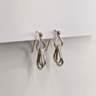 Handcrafted silver earrings featuring a trio of raindrop pendants. Approximately 1” in length. Side view.