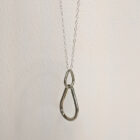 A handcrafted silver necklace showcasing two interlinked raindrop pendants. Chain is approximately 9“in length. Raindrop pendants approximately 1.25”.