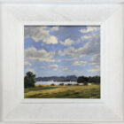 lake district art original oil painting by local artist Jeff Sudders. Blue cloudy sky green fields and sailboats in the distance on lake Windermere. Displayed in a white wood grain frame.