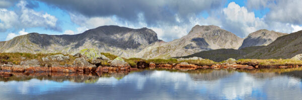 craggy and harsh looking Scafell and Scafell Pike over Three Tarns below Bowfell in the langdale valley in the lake district