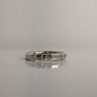 A thin silver ring with small indents across the band. Approximately 0.7” in diameter..Handmade by Helen Wiseman.