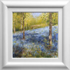 Lake District art original oil painting by Jeff Sudders A Walk in Jeffey Knotts Wood Ambleside. Woodland scene with bluebells covering the ground. A couple walking in the distance. In a white cushioned frame.