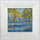 lake district art original oil painting by local artist Jeff Sudders. A beautiful scene of Jeffey Knotts woodland full of bluebells and trees with a couple walking in the distance. Display in a white wood grain frame.