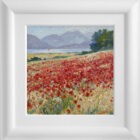 Lake District art original oil painting by Jeff Sudders. A vibrant piece summer colours of a poppy field with a lake and fells in the distance and a red sailboat floating on the water. Displayed in a white cushioned frame.