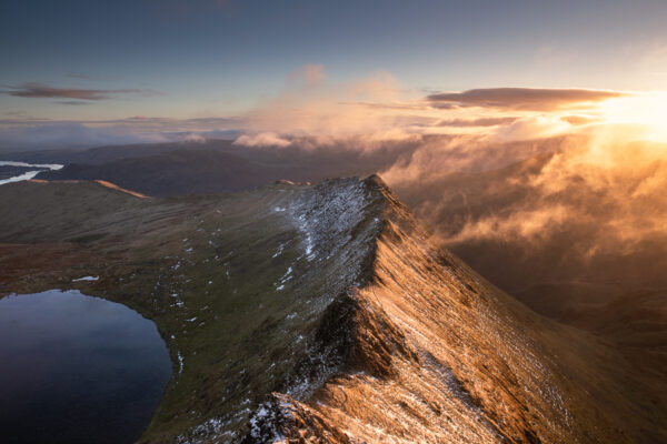 Print by Lake District Photographer Nathan Buckley. Sunrise over striding edge. view from helvellyn of misty fell red tarn ullswater in winter snow