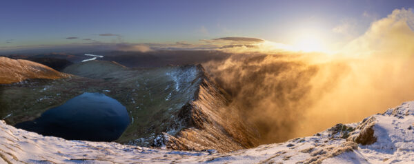 Print by Lake District Photographer Nathan Buckley. Sunrise over striding edge. panomaric view from helvellyn of misty fell red tarn ullswater in winter snow