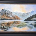 Limited edition print on canvas by Ben Goymour featuring wastwater. The still and calm lake reflect the fells and sunset sky perfectly. Displayed ina black frame with bronze trim.