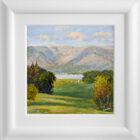 Lake District art original oil painting by Jeff Sudders of a green valley a lake with sailboats and mountains beneath a blue cloud filled sky. Displayed in white frame.